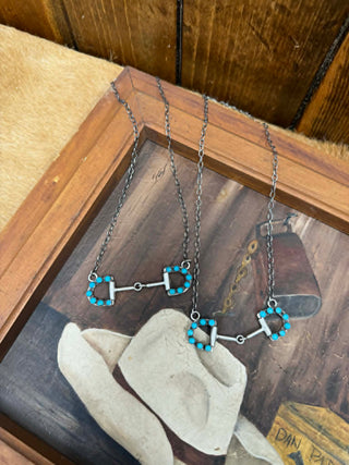 Necklace with turquoise accents on a rustic wooden surface