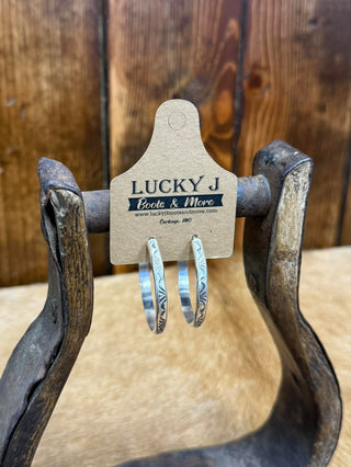 sterling Silver earrings on a wooden stand with a 'Lucky J' tag.