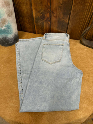 Light blue denim vest on a wooden surface