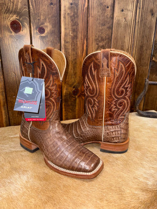 A pair of navy cowboy boots with a square toe and detailed stitching, made from caiman belly leather.