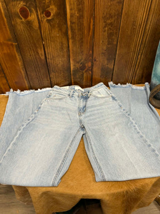 Light blue denim shorts on a wooden surface
