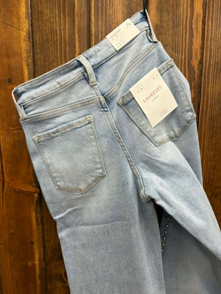 Light blue jeans with a tag on a wooden background