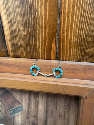Jewelry set with turquoise beads on a wooden surface