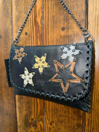 Kurtmen Raelyn Clutch, black leather clutch, petite fold over bag, metallic star purse, designer leather handbag, crystal accent clutch, artisanal leather bag, luxury evening clutch.